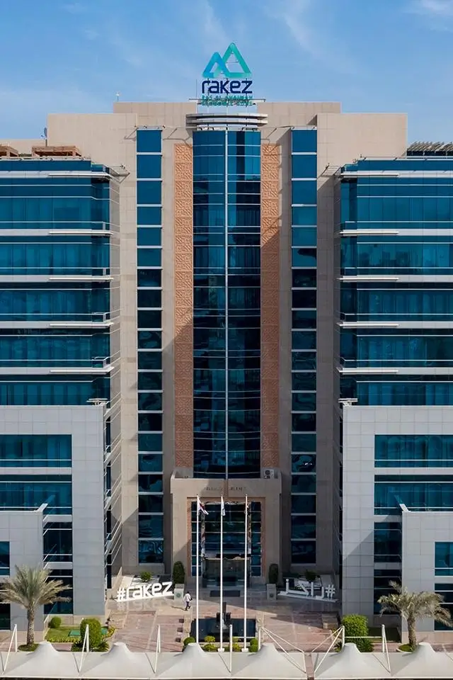 Modern RAKEZ Free Zone buildings in Ras Al Khaimah with office complexes, warehouses, industrial facilities, and port infrastructure showcasing UAE business setup environment